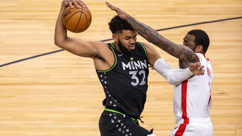 Mar 26, 2021; Minneapolis, Minnesota, USA; Minnesota Timberwolves center Karl-Anthony Towns (32) drives to the basket as Houston Rockets guard John Wall (1) plays defense in the first half at Target Center. Mandatory Credit: Jesse Johnson-USA TODAY Sports