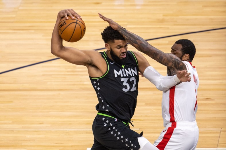 Mar 26, 2021; Minneapolis, Minnesota, USA; Minnesota Timberwolves center Karl-Anthony Towns (32) drives to the basket as Houston Rockets guard John Wall (1) plays defense in the first half at Target Center. Mandatory Credit: Jesse Johnson-USA TODAY Sports