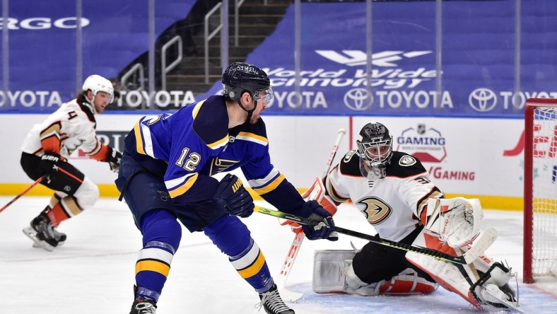 Mar 26, 2021; St. Louis, Missouri, USA;  St. Louis Blues left wing Zach Sanford (12) shoots as Anaheim Ducks goaltender John Gibson (36) defends the net during the third period at Enterprise Center. Mandatory Credit: Jeff Curry-USA TODAY Sports