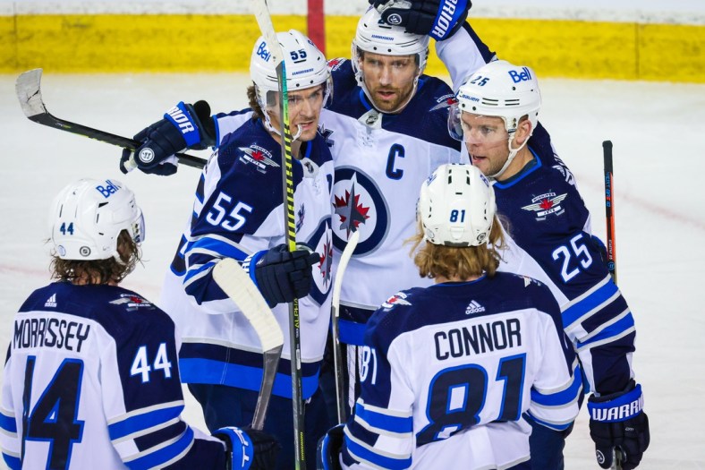 Mar 26, 2021; Calgary, Alberta, CAN; Winnipeg Jets center Paul Stastny (25) celebrates his goal with his teammates against the Calgary Flames during the third period at Scotiabank Saddledome. Mandatory Credit: Sergei Belski-USA TODAY Sports