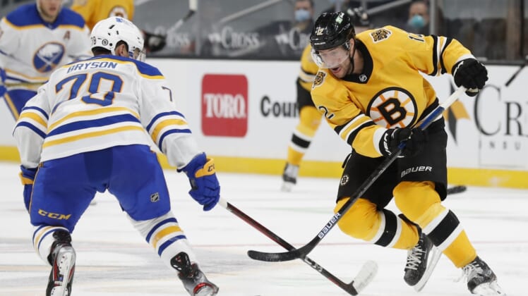 Mar 27, 2021; Boston, Massachusetts, USA; Boston Bruins right wing Craig Smith (12) tries to get past Buffalo Sabres defenseman Jacob Bryson (78) during the third period at TD Garden. Mandatory Credit: Winslow Townson-USA TODAY Sports
