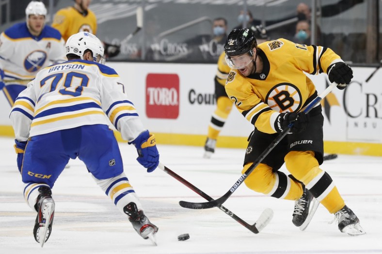 Mar 27, 2021; Boston, Massachusetts, USA; Boston Bruins right wing Craig Smith (12) tries to get past Buffalo Sabres defenseman Jacob Bryson (78) during the third period at TD Garden. Mandatory Credit: Winslow Townson-USA TODAY Sports