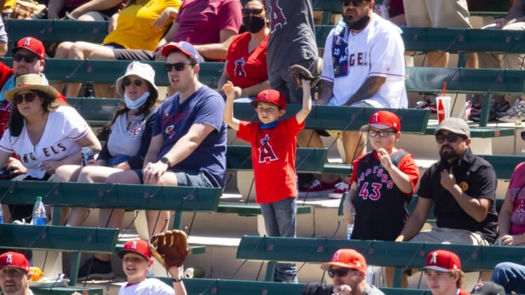 Mar 27, 2021; Tempe, Arizona, USA; A young Los Angeles Angels fan in the crowd asks for a ball against the San Diego Padres during a Spring Training game at Tempe Diablo Stadium. Mandatory Credit: Mark J. Rebilas-USA TODAY Sports
