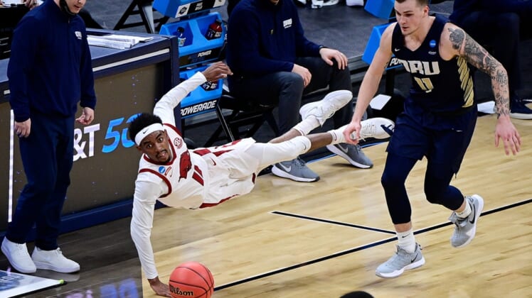 Mar 27, 2021; Indianapolis, Indiana, USA; Arkansas Razorbacks guard Jalen Tate (11) dives for a loose ball during the second half against Oral Roberts Golden Eagles in the Sweet Sixteen of the 2021 NCAA Tournament at Bankers Life Fieldhouse. Mandatory Credit: Marc Lebryk-USA TODAY Sports
