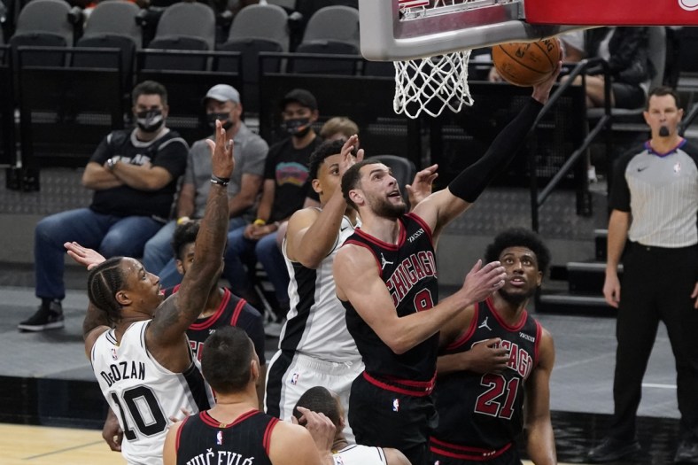 Mar 27, 2021; San Antonio, Texas, USA; Chicago Bulls guard Zach LaVine (8) lays in a basket as San Antonio Spurs forward DeMar DeRozan (10) looks on in the second quarter at AT&T Center. Mandatory Credit: Scott Wachter-USA TODAY Sports
