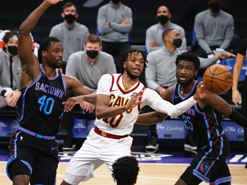 Mar 27, 2021; Sacramento, California, USA; Cleveland Cavaliers guard Darius Garland (10) passes the ball against Sacramento Kings forward Harrison Barners (40) and forward Chimezie Metu (25) during the first quarter at Golden 1 Center. Mandatory Credit: Kelley L Cox-USA TODAY Sports