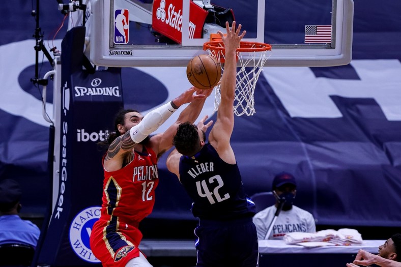 Mar 27, 2021; New Orleans, Louisiana, USA;  New Orleans Pelicans center Steven Adams (12) blocks the shot of Dallas Mavericks forward Maxi Kleber (42) as he goes to the basket during the second half at the Smoothie King Center. Mandatory Credit: Stephen Lew-USA TODAY Sports