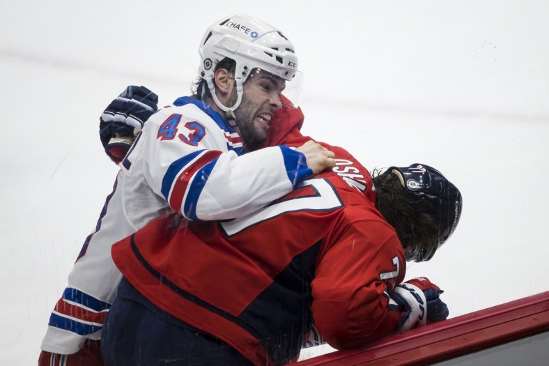 Mar 28, 2021; Washington, District of Columbia, USA; New York Rangers center Colin Blackwell (43) throws a puch at Washington Capitals right wing T.J. Oshie (77) during the first period at Capital One Arena. Mandatory Credit: Scott Taetsch-USA TODAY Sports