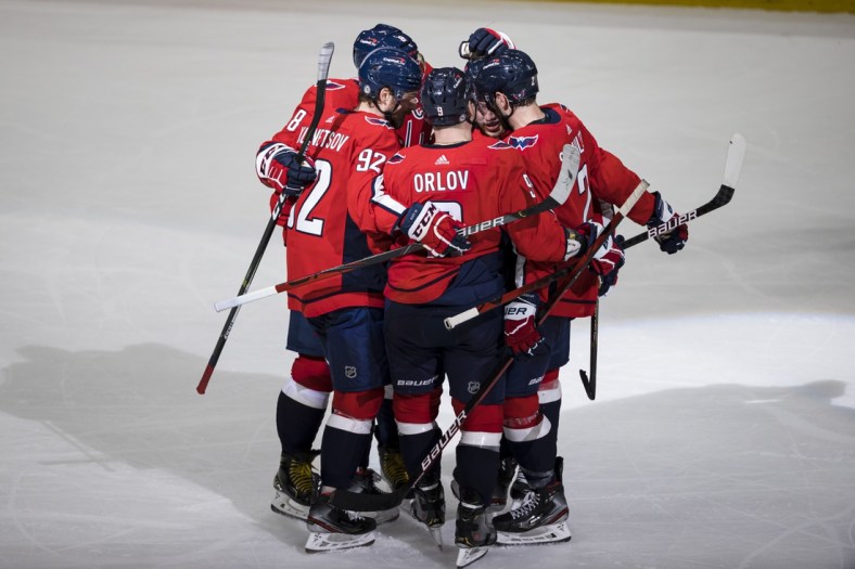 Mar 28, 2021; Washington, District of Columbia, USA; Washington Capitals right wing T.J. Oshie (77) celebrates with center Evgeny Kuznetsov (92) defenseman Dmitry Orlov (9) left wing Alex Ovechkin (8) and defenseman Justin Schultz (2) after scoring a goal against the New York Rangers during the third period at Capital One Arena. Mandatory Credit: Scott Taetsch-USA TODAY Sports