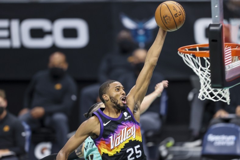 Mar 28, 2021; Charlotte, North Carolina, USA; Phoenix Suns forward Mikal Bridges (25) drives for a dunk against the Charlotte Hornets during the fourth quarter at Spectrum Center. The Phoenix Suns won 101-97 in overtime. Mandatory Credit: Nell Redmond-USA TODAY Sports