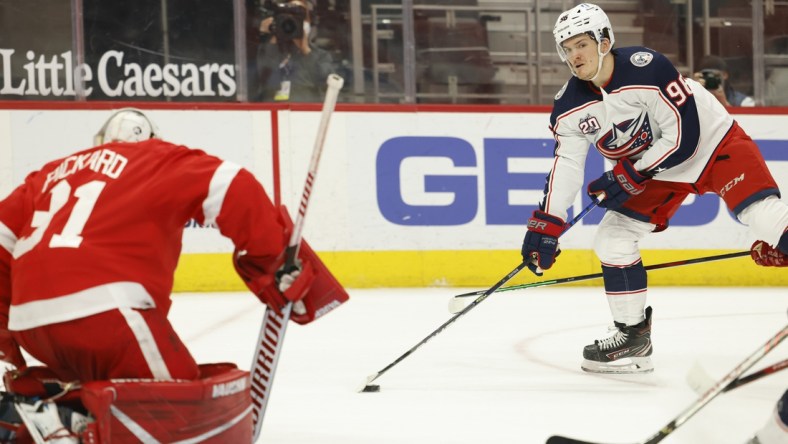 Mar 28, 2021; Detroit, Michigan, USA;  Columbus Blue Jackets center Jack Roslovic (96) skates in on Detroit Red Wings goaltender Calvin Pickard (31) in the first period at Little Caesars Arena. Mandatory Credit: Rick Osentoski-USA TODAY Sports