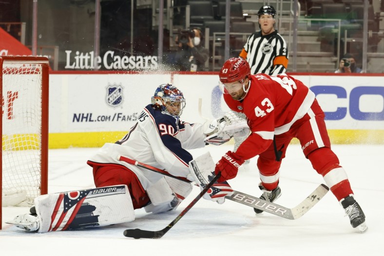 Mar 28, 2021; Detroit, Michigan, USA;  Detroit Red Wings left wing Darren Helm (43) shoots the puck on Columbus Blue Jackets goaltender Elvis Merzlikins (90) in the second period at Little Caesars Arena. Mandatory Credit: Rick Osentoski-USA TODAY Sports