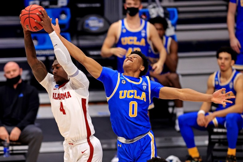 Mar 28, 2021; Indianapolis, Indiana, USA; Alabama Crimson Tide forward Juwan Gary (4) and UCLA Bruins guard Jaylen Clark (0) go for a rebound during the first half in the Sweet Sixteen of the 2021 NCAA Tournament at Hinkle Fieldhouse. Mandatory Credit: Aaron Doster-USA TODAY Sports