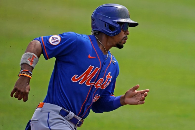 Mar 29, 2021; Jupiter, Florida, USA; New York Mets shortstop Francisco Lindor (12) rounds third base to score a run in the 1st inning of the spring training game against the St. Louis Cardinals at Roger Dean Chevrolet Stadium. Mandatory Credit: Jasen Vinlove-USA TODAY Sports
