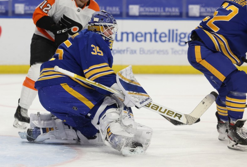 Mar 29, 2021; Buffalo, New York, USA;  Buffalo Sabres goaltender Linus Ullmark (35) looks for the puck after making a save against the Philadelphia Flyers during the first period at KeyBank Center. Mandatory Credit: Timothy T. Ludwig-USA TODAY Sports