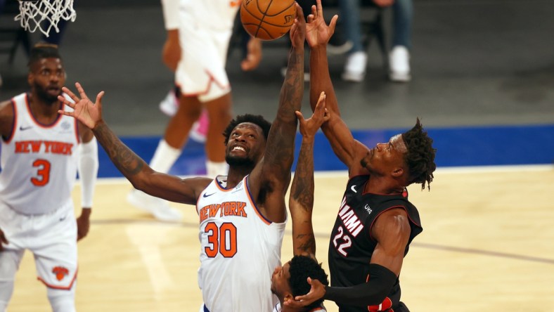 Mar 29, 2021; New York, New York, USA;  New York Knicks forward Julius Randle (30) and Miami Heat forward Jimmy Butler (22) battle for the loose ball at Madison Square Garden. Mandatory Credit: Mike Stobe/POOL PHOTOS-USA TODAY Sports