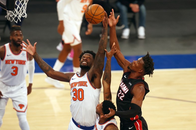 Mar 29, 2021; New York, New York, USA;  New York Knicks forward Julius Randle (30) and Miami Heat forward Jimmy Butler (22) battle for the loose ball at Madison Square Garden. Mandatory Credit: Mike Stobe/POOL PHOTOS-USA TODAY Sports