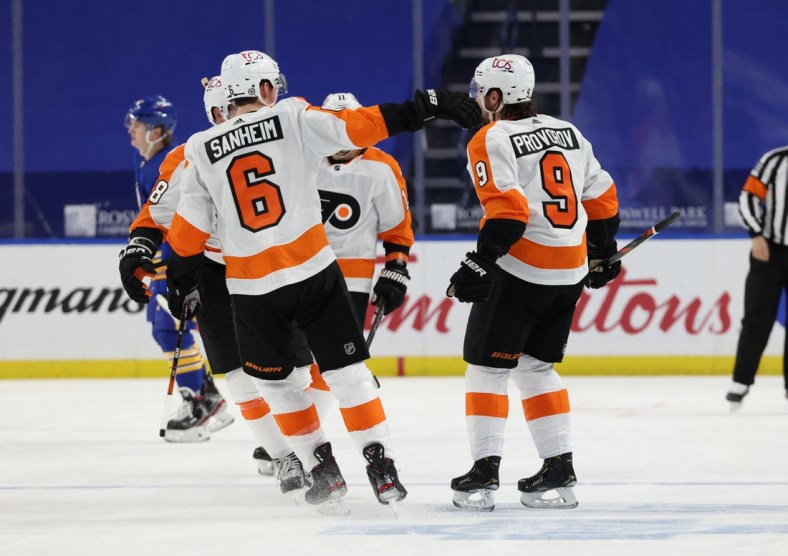 Mar 29, 2021; Buffalo, New York, USA;  Philadelphia Flyers defenseman Ivan Provorov (9) celebrates with teammates after scoring an overtime goal against the Buffalo Sabres at KeyBank Center. Mandatory Credit: Timothy T. Ludwig-USA TODAY Sports