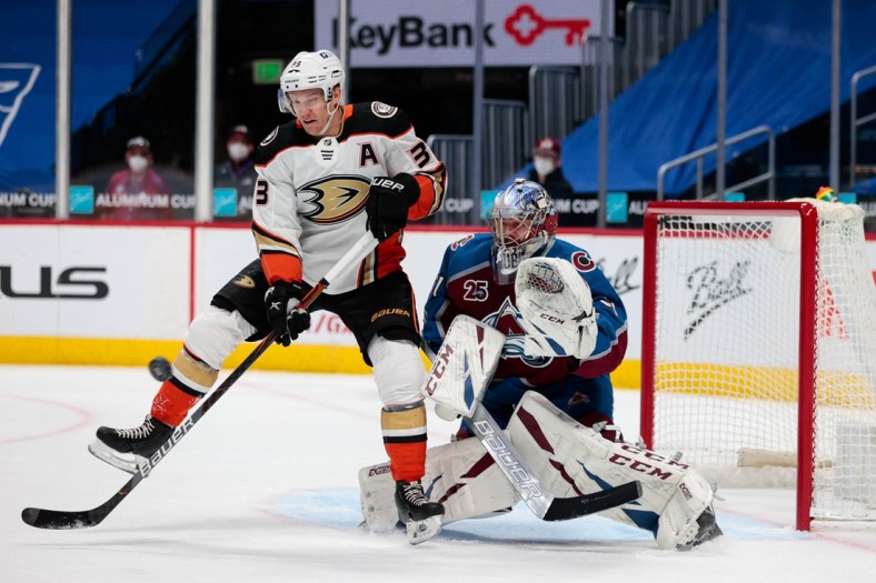 Mar 29, 2021; Denver, Colorado, USA; Anaheim Ducks right wing Jakob Silfverberg (33) attempts to redirect the puck past Colorado Avalanche goaltender Philipp Grubauer (31) in the first period at Ball Arena. Mandatory Credit: Isaiah J. Downing-USA TODAY Sports