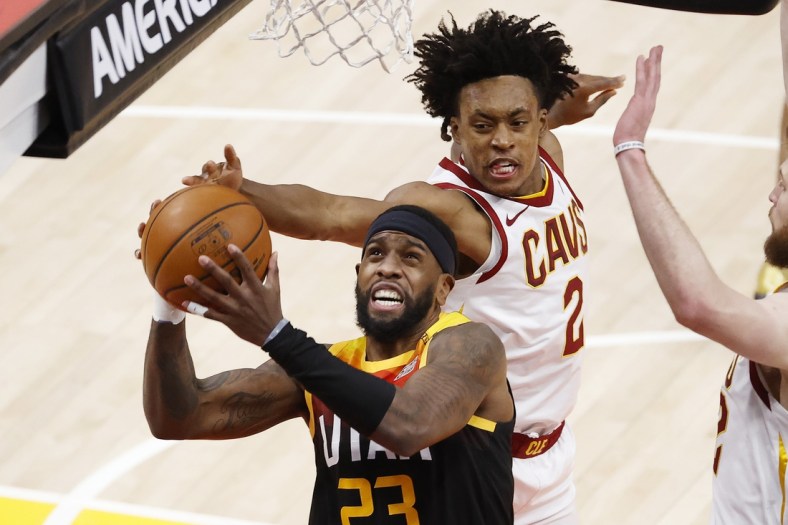 Mar 29, 2021; Salt Lake City, Utah, USA; Utah Jazz forward Royce O'Neale (23) and Cleveland Cavaliers guard Collin Sexton (2) battle in the second quarter at Vivint Smart Home Arena. Mandatory Credit: Jeffrey Swinger-USA TODAY Sports