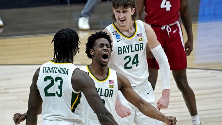 Mar 29, 2021; Indianapolis, Indiana, USA; Baylor Bears forward Jonathan Tchamwa Tchatchoua (23) celebrates with guard Adam Flagler (10) and guard Matthew Mayer (24) during the second half against the Arkansas Razorbacks in the Elite Eight of the 2021 NCAA Tournament at Lucas Oil Stadium. Mandatory Credit: Robert Deutsch-USA TODAY Sports