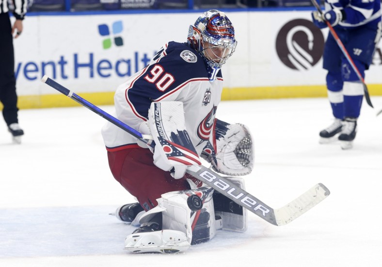 Mar 30, 2021; Tampa, Florida, USA ; Columbus Blue Jackets goaltender Elvis Merzlikins (90) makes a save against the Tampa Bay Lightning during the third period at Amalie Arena. Mandatory Credit: Kim Klement-USA TODAY Sports