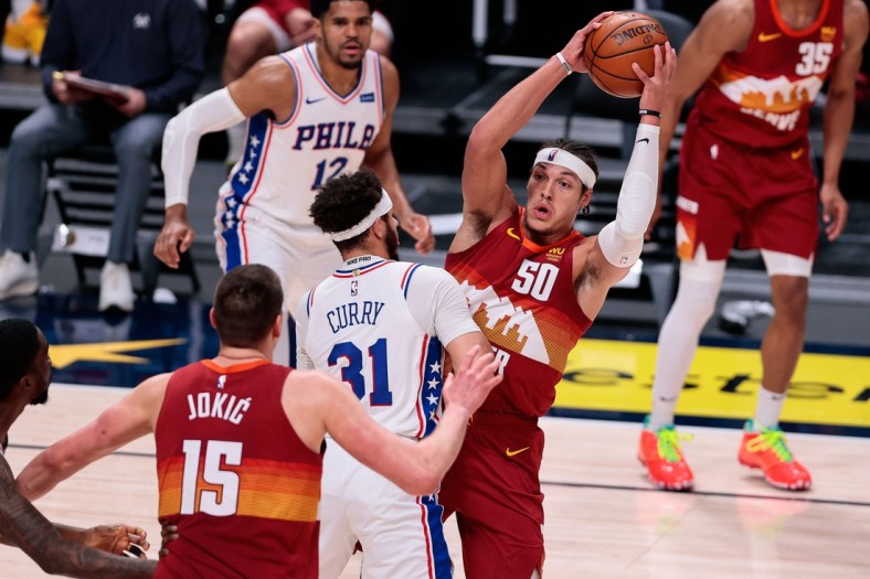Mar 30, 2021; Denver, Colorado, USA; Denver Nuggets forward Aaron Gordon (50) corns the ball against Philadelphia 76ers guard Seth Curry (31) in the second quarter at Ball Arena. Mandatory Credit: Isaiah J. Downing-USA TODAY Sports