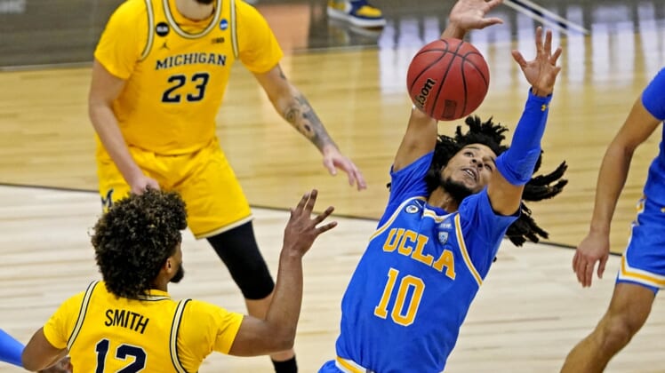 Mar 30, 2021; Indianapolis, IN, USA; UCLA Bruins guard Tyger Campbell (10) blocks a pass by Michigan Wolverines guard Mike Smith (12) during the second half in the Elite Eight of the 2021 NCAA Tournament at Lucas Oil Stadium. Mandatory Credit: Robert Deutsch-USA TODAY Sports