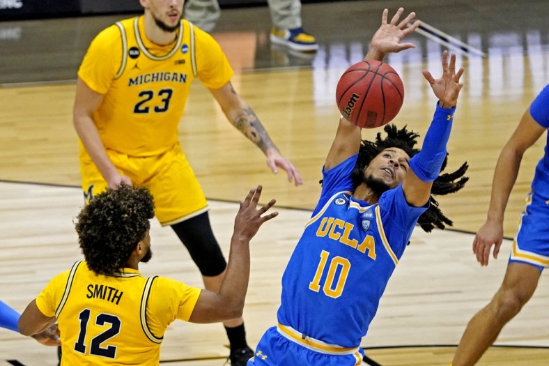 Mar 30, 2021; Indianapolis, IN, USA; UCLA Bruins guard Tyger Campbell (10) blocks a pass by Michigan Wolverines guard Mike Smith (12) during the second half in the Elite Eight of the 2021 NCAA Tournament at Lucas Oil Stadium. Mandatory Credit: Robert Deutsch-USA TODAY Sports