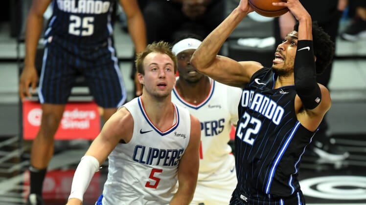Mar 30, 2021; Los Angeles, California, USA; Orlando Magic forward Otto Porter Jr. (22) goes to the basket as Los Angeles Clippers guard Luke Kennard (5) looks on during the first half at Staples Center. Mandatory Credit: Jayne Kamin-Oncea-USA TODAY Sports