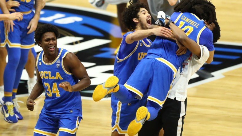 Mar 30, 2021; Indianapolis, IN, USA; UCLA Bruins guard Johnny Juzang (3) and guard Tyger Campbell (10) celebrate after defeating the Michigan Wolverines in the Elite Eight of the 2021 NCAA Tournament at Lucas Oil Stadium. Mandatory Credit: Mark J. Rebilas-USA TODAY Sports