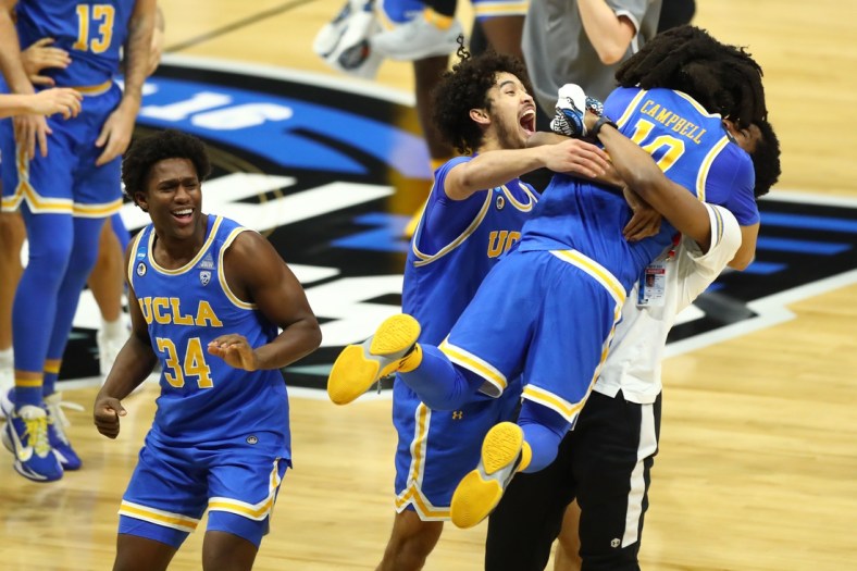 Mar 30, 2021; Indianapolis, IN, USA; UCLA Bruins guard Johnny Juzang (3) and guard Tyger Campbell (10) celebrate after defeating the Michigan Wolverines in the Elite Eight of the 2021 NCAA Tournament at Lucas Oil Stadium. Mandatory Credit: Mark J. Rebilas-USA TODAY Sports
