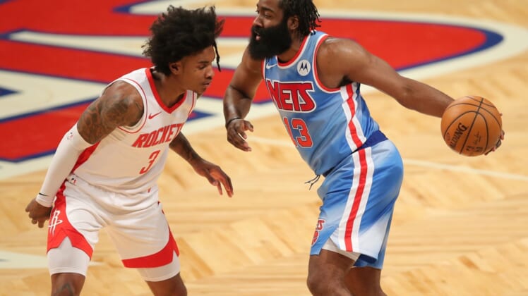Mar 31, 2021; Brooklyn, New York, USA; Brooklyn Nets shooting guard James Harden (13) dribbles the ball against Houston Rockets shooting guard Kevin Porter Jr. (3) during the first quarter at Barclays Center. Mandatory Credit: Brad Penner-USA TODAY Sports