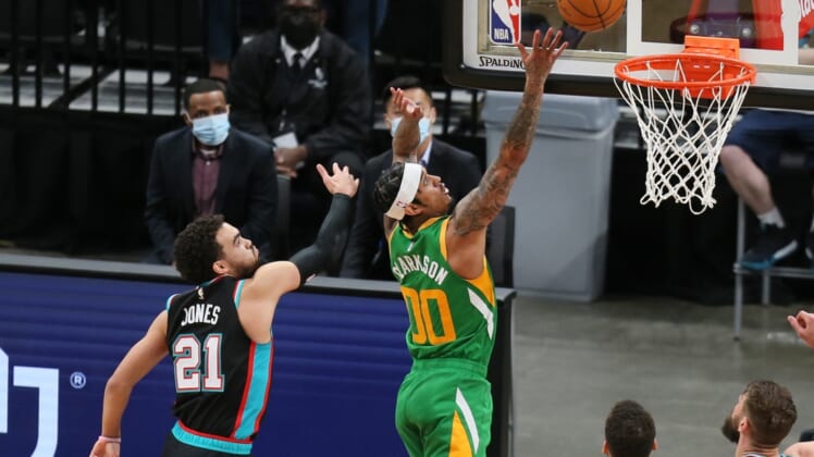 Mar 31, 2021; Memphis, Tennessee, USA; Utah Jazz guard Jordan Clarkson (00) shoots the ball while defended by Memphis Grizzlies guard Tyus Jones (21) during the fourth quarter at FedExForum. Mandatory Credit: Nelson Chenault-USA TODAY Sports