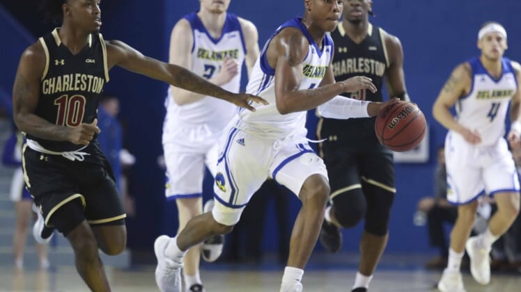 Delaware's Kevin Anderson pushes the ball up court ahead of the pack including Charleston's Zep Jasper (left) in the first half at the Bob Carpenter Center Thursday.Ud V Charleston