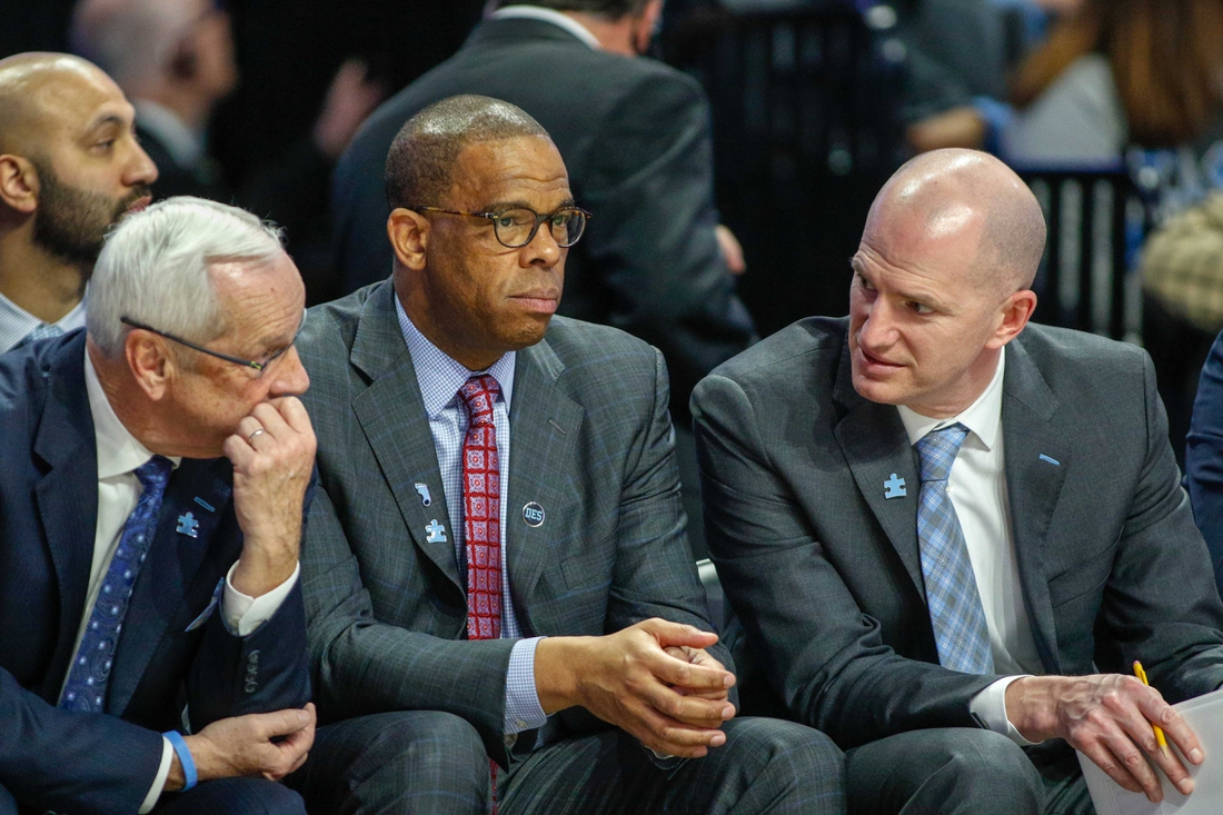 Feb 16, 2019; Winston-Salem, NC, USA; North Carolina Tar Heels head coach Roy Williams, left, talks to assistant coaches Hubert Davis, center, and Brad Frederick as the North Carolina Tar Heels play the Wake Forest Demon Deacons in the second half at Lawrence Joel Coliseum. The North Carolina Tar Heels won 95-57. Mandatory Credit: Nell Redmond-USA TODAY Sports