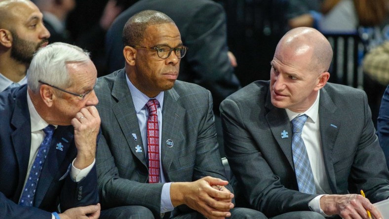 Feb 16, 2019; Winston-Salem, NC, USA; North Carolina Tar Heels head coach Roy Williams, left, talks to assistant coaches Hubert Davis, center, and Brad Frederick as the North Carolina Tar Heels play the Wake Forest Demon Deacons in the second half at Lawrence Joel Coliseum. The North Carolina Tar Heels won 95-57. Mandatory Credit: Nell Redmond-USA TODAY Sports