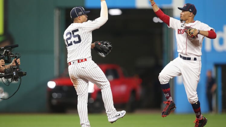 Jul 9, 2019; Cleveland, OH, USA;  American League second baseman Gleyber Torres (25) of the New York Yankees and center fielder Mookie Betts (50) of the Boston Red Sox celebrate after defeating the National League in the 2019 MLB All Star Game at Progressive Field. Mandatory Credit: Charles LeClaire-USA TODAY Sports