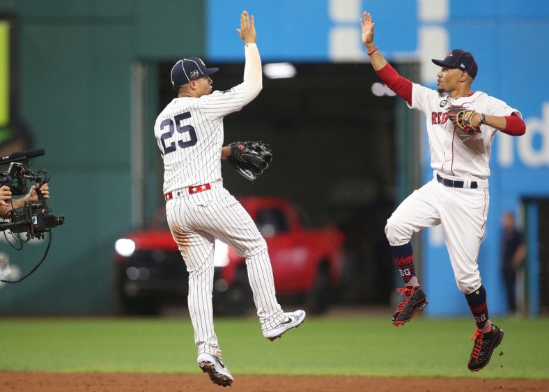 Jul 9, 2019; Cleveland, OH, USA;  American League second baseman Gleyber Torres (25) of the New York Yankees and center fielder Mookie Betts (50) of the Boston Red Sox celebrate after defeating the National League in the 2019 MLB All Star Game at Progressive Field. Mandatory Credit: Charles LeClaire-USA TODAY Sports