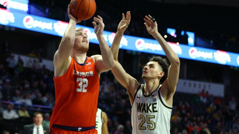 Feb 1, 2020; Winston-Salem, North Carolina, USA; Clemson Tigers forward Paul Grinde (32) shoots the ball against Wake Forest Demon Deacons forward Ismael Massoud (25) during the second half at Lawrence Joel Veterans Memorial Coliseum. Mandatory Credit: Jeremy Brevard-USA TODAY Sports