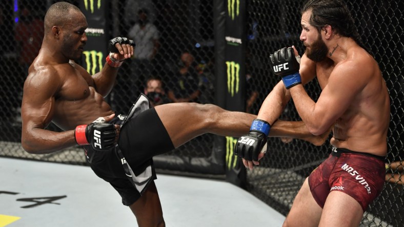 July 12, 2020; Abu Dhabi, UAE;  Kamaru Usman of Nigeria kicks Jorge Masvidal in their UFC welterweight championship fight during the UFC 251 event at Flash Forum on UFC Fight Island on July 12, 2020 on Yas Island, Abu Dhabi, United Arab Emirates.  Mandatory Credit: Jeff Bottari/Zuffa LLC via USA TODAY Sports