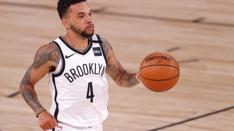 Aug 11, 2020; Lake Buena Vista, Florida, USA; Chris Chiozza #4 of the Brooklyn Nets moves the ball against the Orlando Magic during the first half at AdventHealth Arena. Mandatory Credit: Mike Ehrmann/Pool Photo-USA TODAY Sports