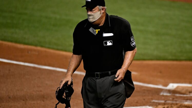 Sep 11, 2020; Miami, Florida, USA;  Home Plate umpire Joe West (22) walks on the field between innings of the game between the Miami Marlins and the Philadelphia Phillies at Marlins Park. Mandatory Credit: Jasen Vinlove-USA TODAY Sports