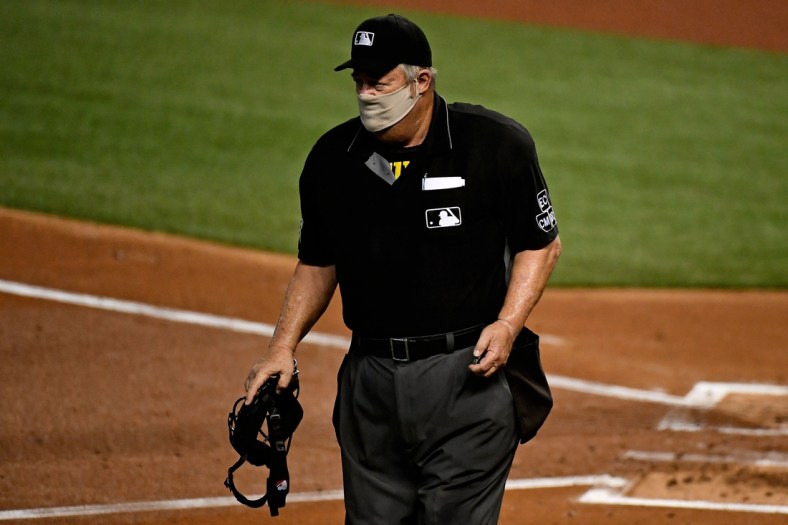 Sep 11, 2020; Miami, Florida, USA;  Home Plate umpire Joe West (22) walks on the field between innings of the game between the Miami Marlins and the Philadelphia Phillies at Marlins Park. Mandatory Credit: Jasen Vinlove-USA TODAY Sports