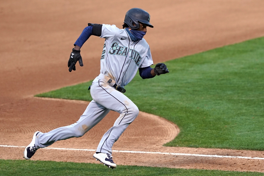 Sep 26, 2020; Oakland, California, USA; Seattle Mariners second baseman Dee Strange-Gordon (9) runs home to score a run against the Oakland Athletics during the fifth inning at Oakland Coliseum. Mandatory Credit: Darren Yamashita-USA TODAY Sports