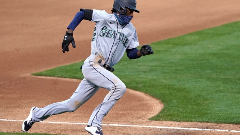 Sep 26, 2020; Oakland, California, USA; Seattle Mariners second baseman Dee Strange-Gordon (9) runs home to score a run against the Oakland Athletics during the fifth inning at Oakland Coliseum. Mandatory Credit: Darren Yamashita-USA TODAY Sports