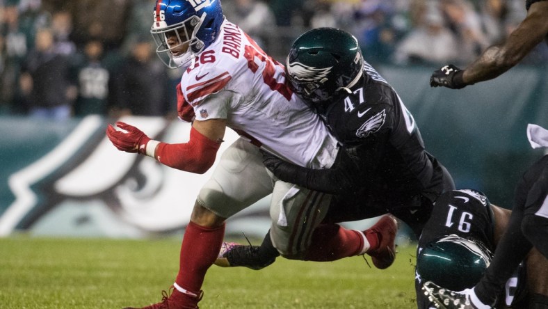 New York's Saquon Barkley (26) is brought down by Philadelphia's Nathan Gerry.Sports Eagles Giants