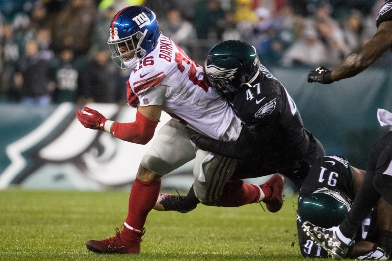 New York's Saquon Barkley (26) is brought down by Philadelphia's Nathan Gerry.Sports Eagles Giants