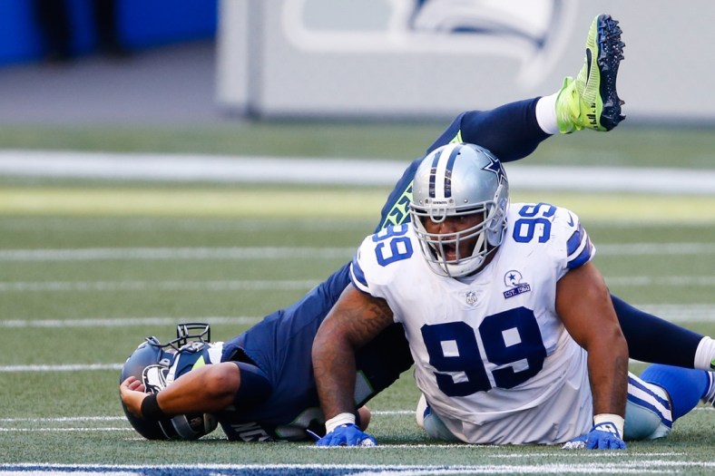 Sep 27, 2020; Seattle, Washington, USA; Dallas Cowboys defensive tackle Antwaun Woods (99) reacts after a sack of Seattle Seahawks quarterback Russell Wilson (3) during the third quarter at CenturyLink Field. Mandatory Credit: Joe Nicholson-USA TODAY Sports