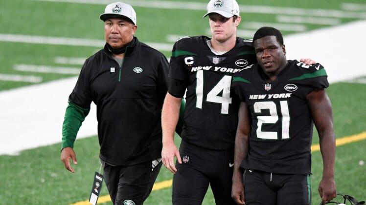 (from left) Offensive coach Hines Ward, New York Jets quarterback Sam Darnold (14), and running back Frank Gore (21) walk off the field after losing to the Denver Broncos, 37-28, at MetLife Stadium on Thursday, Oct. 1, 2020, in East Rutherford.Nfl Jets Broncos